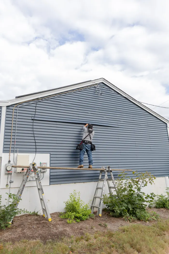 Installer working along the roofline
