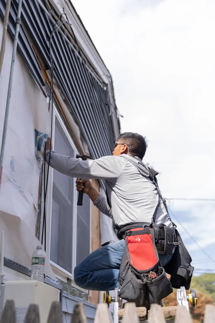 Installer at work on siding and trim